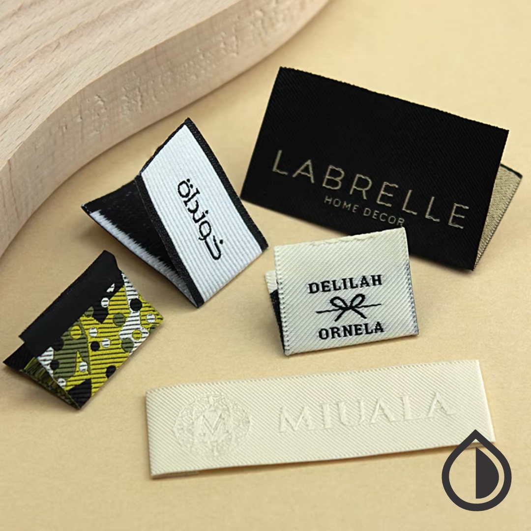 Premium custom cloth labels in Dubai for clothing brands and garments. Fabric, satin, and woven label printing with custom designs and logos.