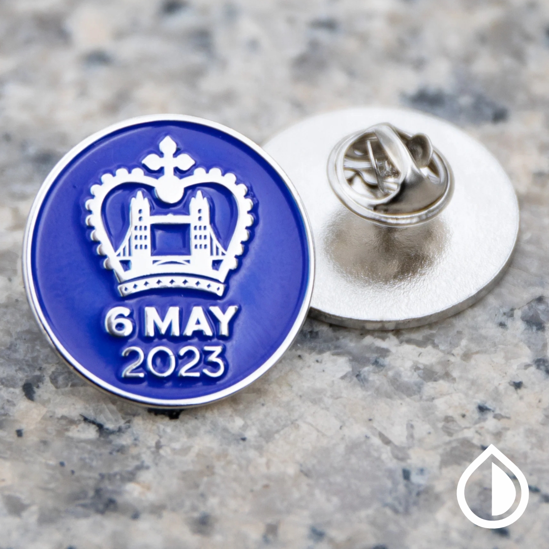 Custom metal pin badge with printed logo and branding, perfect for events, staff uniforms, and promotional use in Dubai.
