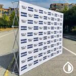 Custom printed backdrops for events, trade shows, and branding in Dubai. High-quality fabric, vinyl, and mesh options with vibrant full-color prints.